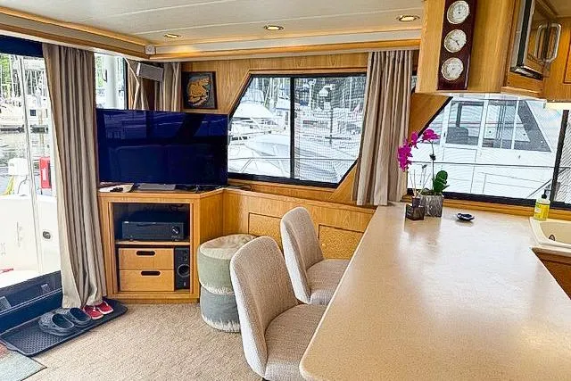 Slide: The Image of Interior of a 1995 Symbol Pilothouse yacht with modern furnishings and large windows. - 21