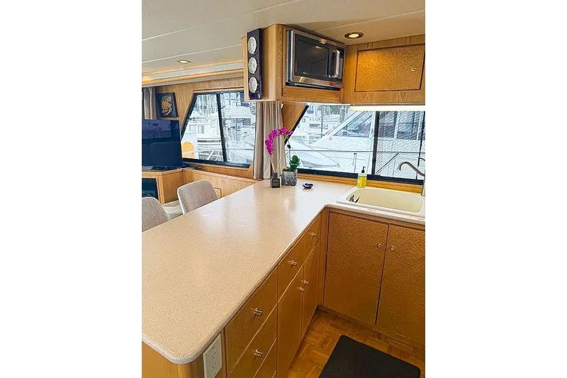 Slide: The Image of Interior of a 1995 Symbol Pilothouse yacht with kitchen and dining area. - 22
