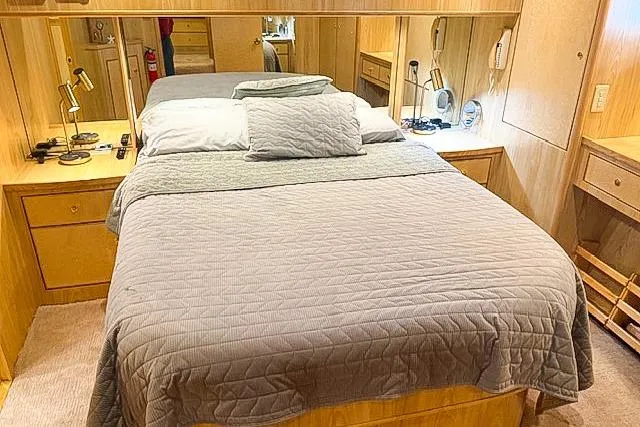 Slide: The Image of Cozy bedroom in 1995 Symbol Pilothouse yacht with wooden decor and soft lighting. - 26