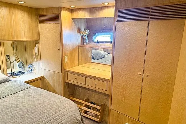 Slide: The Image of Cozy 1995 Symbol Pilothouse bedroom with wood paneling and built-in storage. - 27
