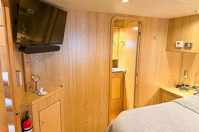 Slide: The Image of Interior of a 1995 Symbol Pilothouse yacht with wood paneling and modern amenities. - 28