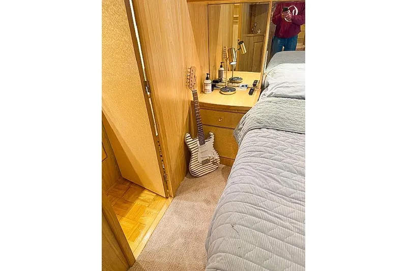 Slide: The Image of Cozy bedroom with guitar, wooden dresser, and mirror on a 1995 Symbol Pilothouse. - 32