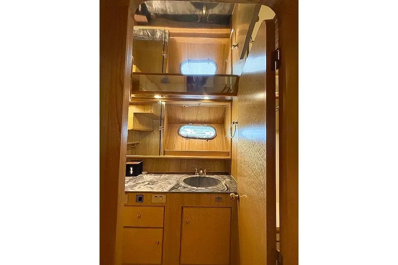 Slide: The Image of Interior of 1995 Symbol Pilothouse yacht with wooden cabinetry and sink. - 35