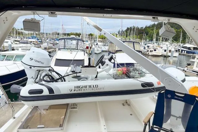 Slide: The Image of A 1995 Symbol Pilothouse with a Highfield Pure Watercraft inflatable boat at a marina. - 4