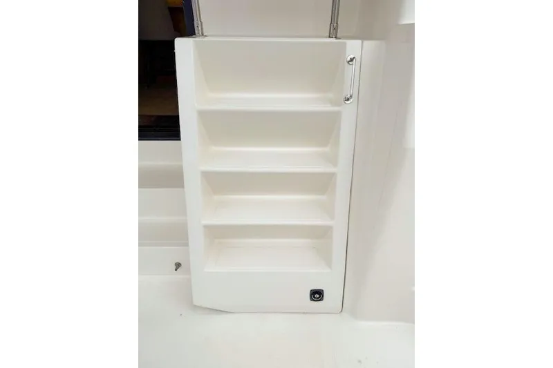 Slide: The Image of White storage shelves on a 1995 Symbol Pilothouse boat interior. - 42