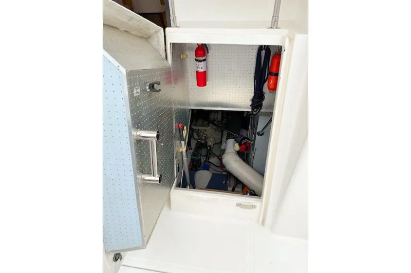 Slide: The Image of Engine compartment of a 1995 Symbol Pilothouse boat with fire extinguisher and equipment. - 43