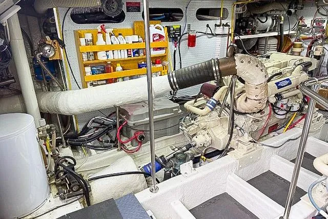 Slide: The Image of Engine room of a 1995 Symbol Pilothouse boat, featuring organized tools and equipment. - 45