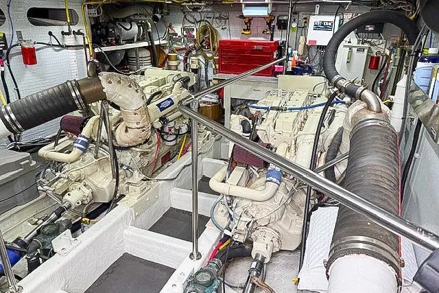 Slide: The Image of Engine room of a 1995 Symbol Pilothouse boat, showcasing dual engines and mechanical components. - 46