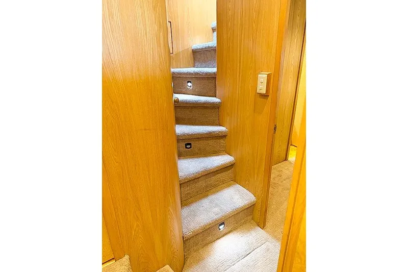 Slide: The Image of Carpeted stairs with wooden walls inside a 1995 Symbol Pilothouse boat. - 5