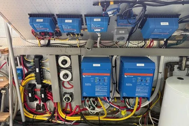 Slide: The Image of Electrical system setup in a 1995 Symbol Pilothouse boat, featuring inverters and wiring. - 51
