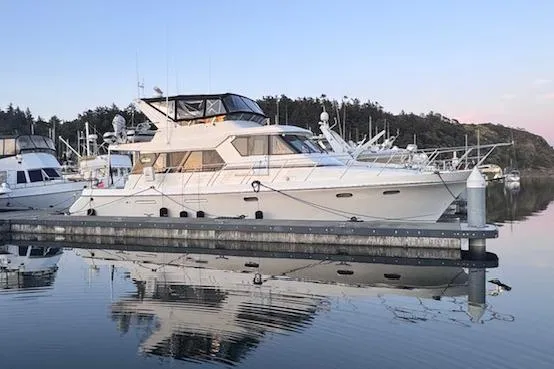 Slide: The Image of 1995 Symbol Pilothouse yacht docked in serene marina at sunset. - 6