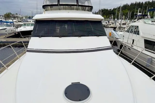 Slide: The Image of 1995 Symbol Pilothouse yacht docked at marina, showcasing sleek design and spacious deck. - 9