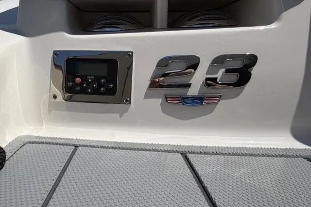 Slide: The Image of 2022 Chaparral 23 SSi boat dashboard with control panel and model emblem. - 12