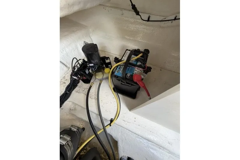 Slide: The Image of 2022 Chaparral 23 SSi boat battery compartment with wiring and components. - 16