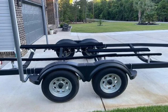 Slide: The Image of Trailer for 2022 Chaparral 23 SSi boat parked on a driveway. - 22