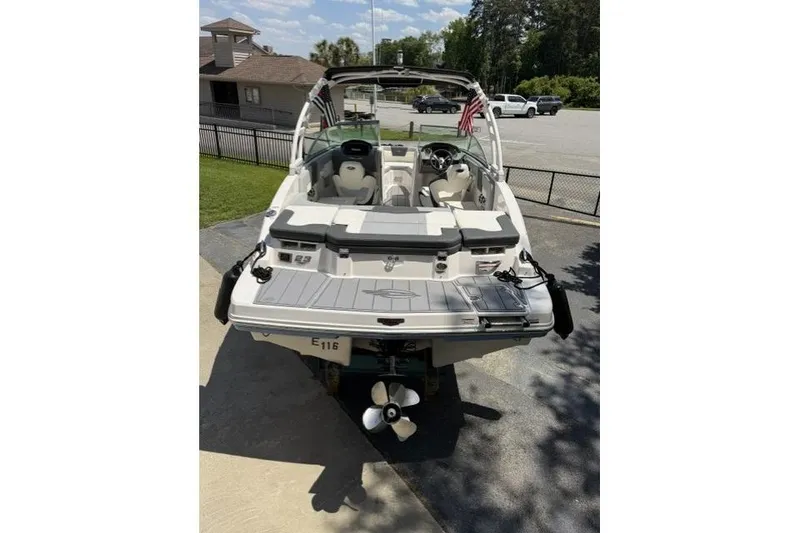 Slide: The Image of 2022 Chaparral 23 SSi boat, rear view, parked on pavement under clear sky. - 3