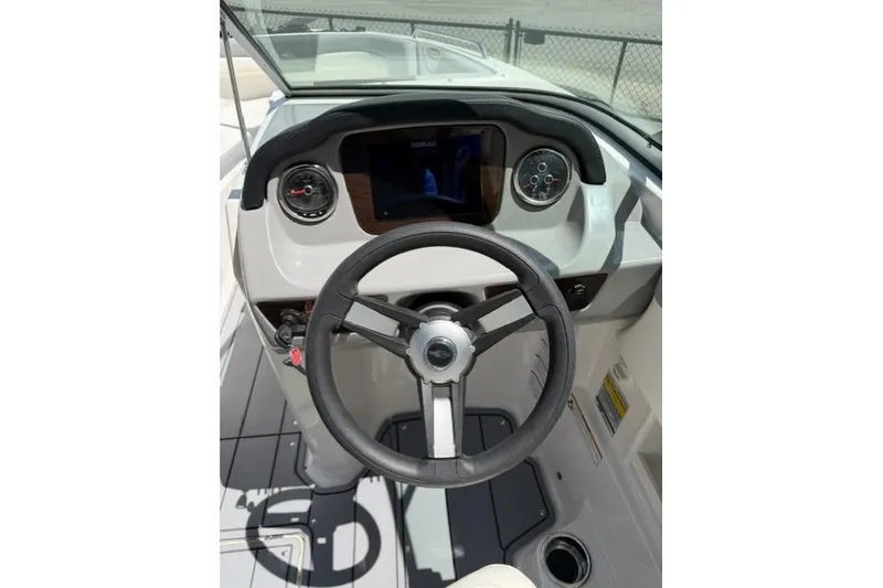 Slide: The Image of 2022 Chaparral 23 SSi boat dashboard with steering wheel and gauges. - 5