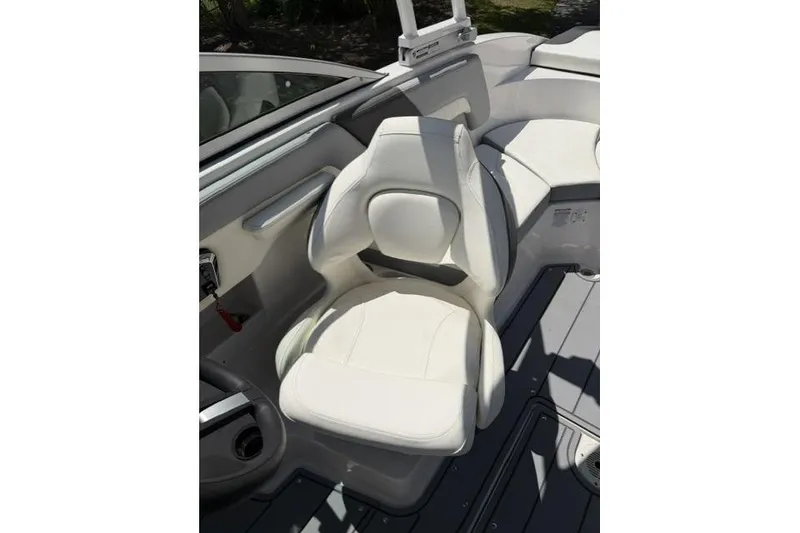Slide: The Image of 2022 Chaparral 23 SSi boat interior with white seating and sleek design. - 6