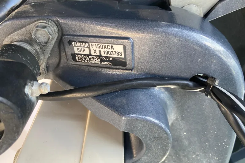 Slide: The Image of 2021 Grady-White Freedom 255 boat with twin 150 horsepower engines docked at marina. - 21
