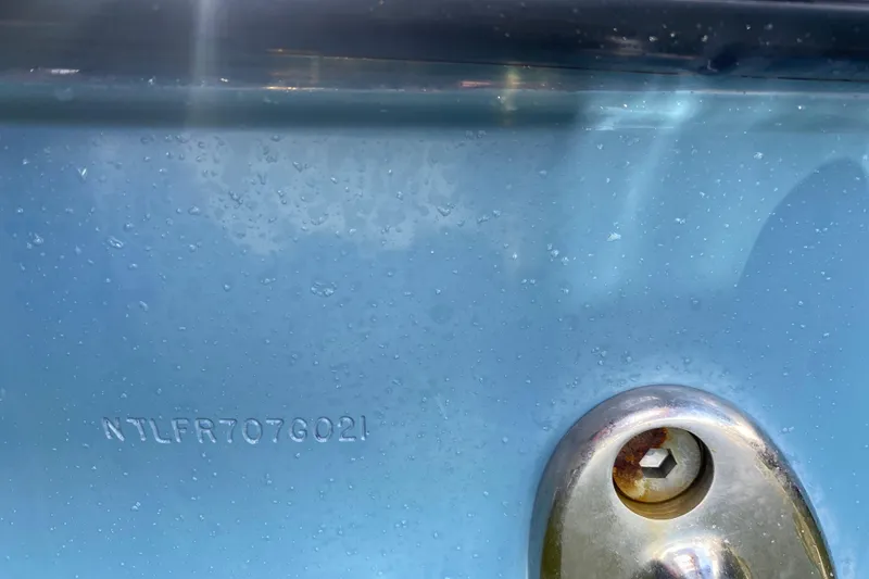 Slide: The Image of 2021 Grady-White Freedom 255 boat with twin 150 horsepower engines docked in a marina. - 22