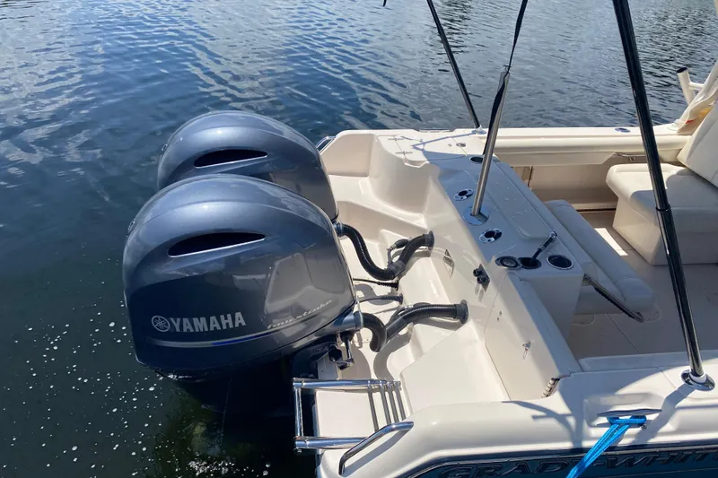 Slide: The Image of 2021 Grady-White Freedom 255 boat with dual Yamaha outboard motors on water. - 24
