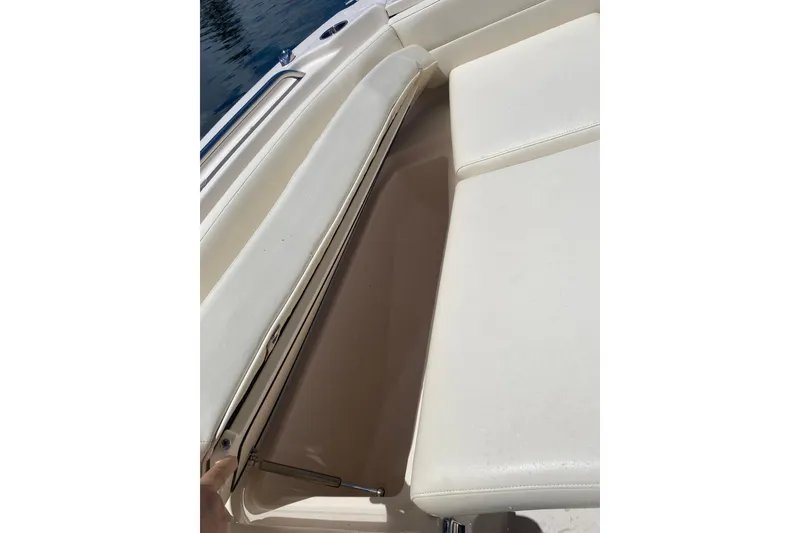 Slide: The Image of 2021 Grady-White Freedom 255 boat, front view, parked outdoors under clear blue sky. - 4
