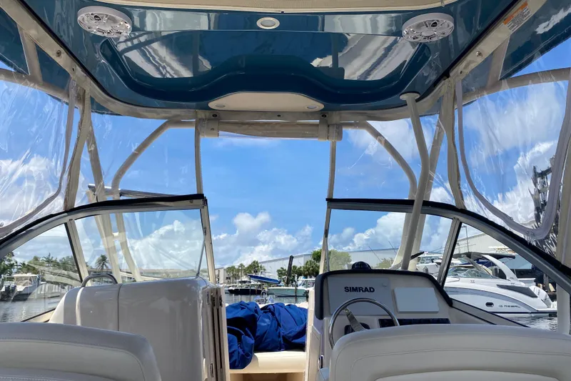 Slide: The Image of 2021 Grady-White Freedom 255 boat docked on a sunny day by the water. - 6