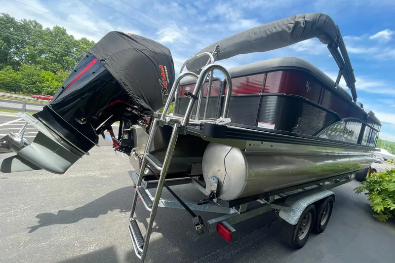 Slide: The Image of 2022 Manitou 23 Oasis pontoon boat on trailer with powerful outboard motor. - 3