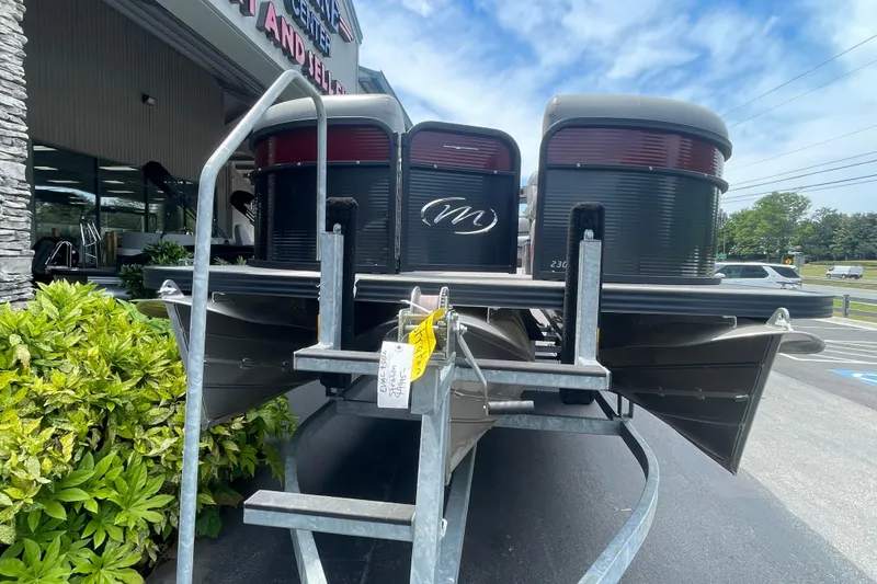 Slide: The Image of 2022 Manitou 23 Oasis pontoon boat on trailer, dealership background. - 4