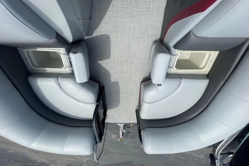 Slide: The Image of Interior view of 2022 Manitou 23 Oasis boat with gray seating and storage compartments. - 5