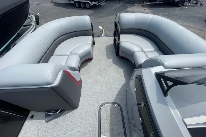 Slide: The Image of 2022 Manitou 23 Oasis boat interior with luxurious gray seating and modern design. - 6