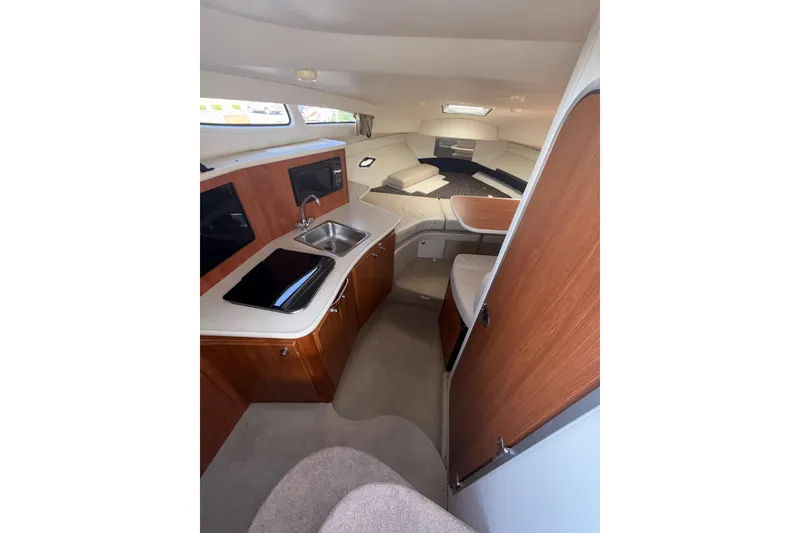 Slide: The Image of Interior of 2003 Bayliner 2655 Ciera boat with kitchenette and seating area. - 12