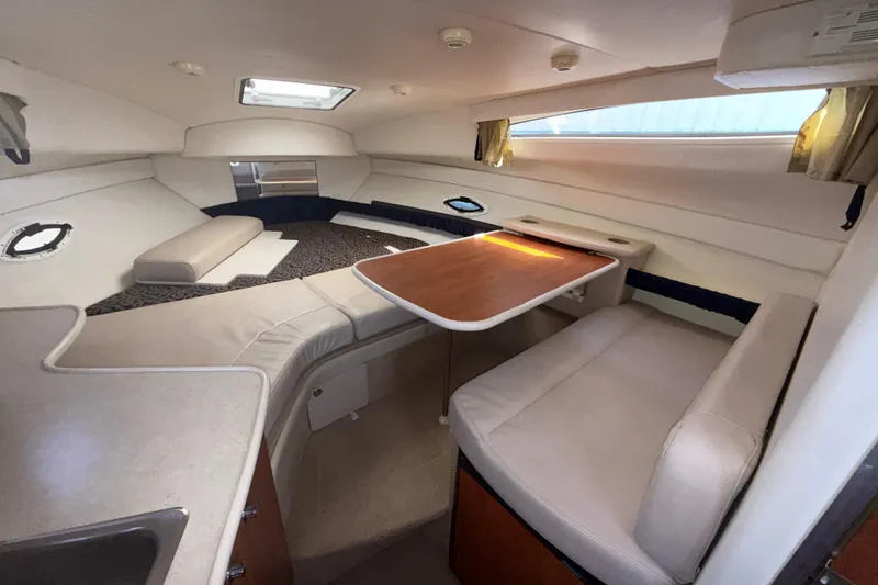 Slide: The Image of Interior of 2003 Bayliner 2655 Ciera boat with seating and table arrangement. - 13