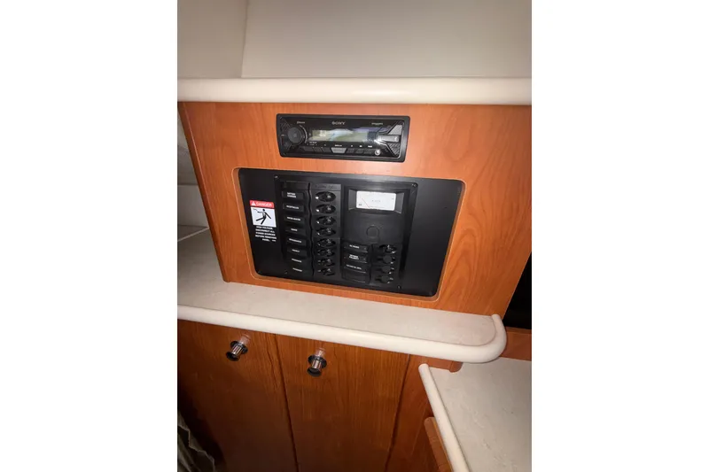 Slide: The Image of 2003 Bayliner 2655 Ciera interior control panel with stereo system and switches. - 19