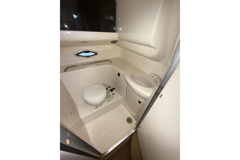 Slide: The Image of 2003 Bayliner 2655 Ciera boat bathroom with toilet, sink, and porthole window. - 20