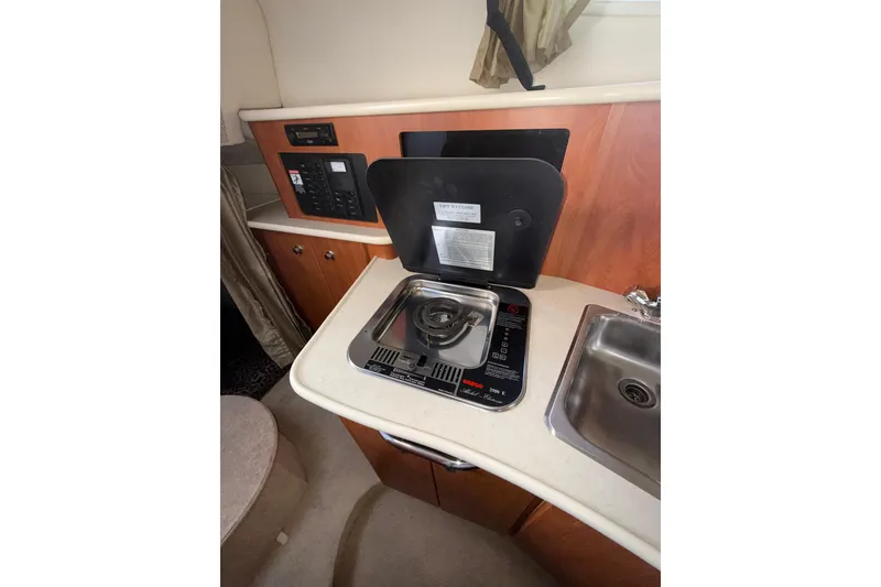 Slide: The Image of Compact kitchen area in a 2003 Bayliner 2655 Ciera boat with stove and sink. - 21