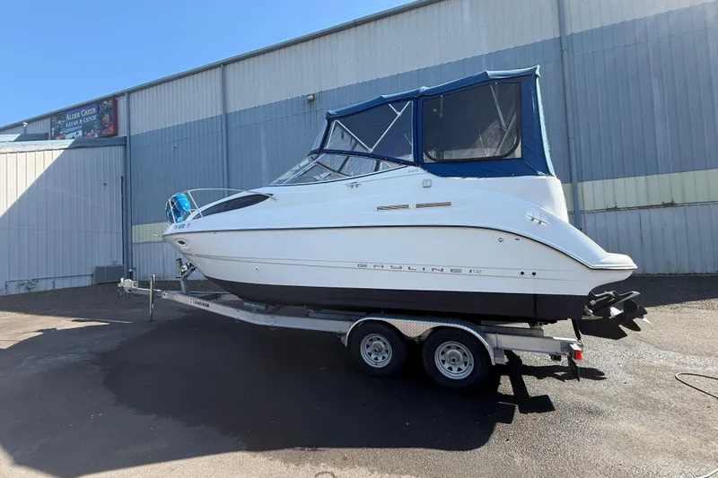 Slide: The Image of 2003 Bayliner 2655 Ciera boat on trailer, parked outside a warehouse. - 3