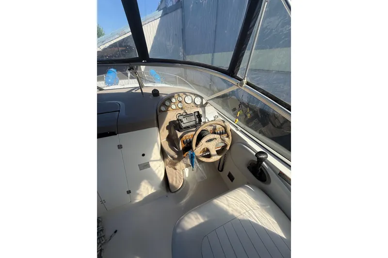 Slide: The Image of 2003 Bayliner 2655 Ciera boat cockpit with steering wheel and control panel. - 5
