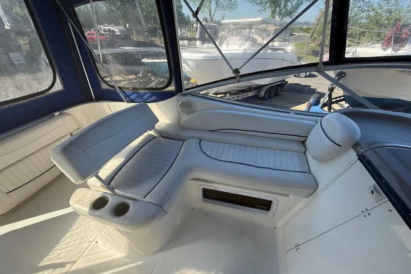 Slide: The Image of 2003 Bayliner 2655 Ciera boat interior with cushioned seating and cup holders. - 7