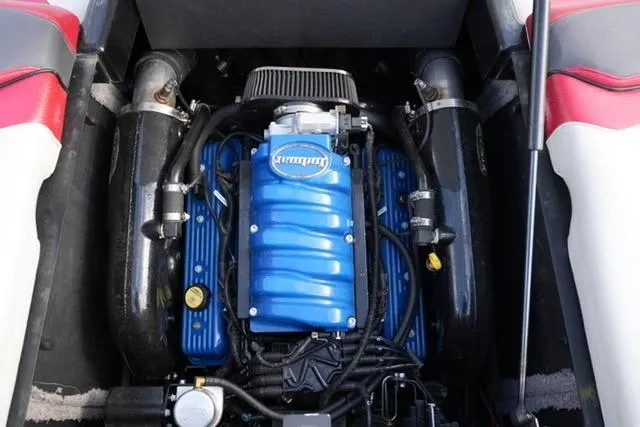 Slide: The Image of 2014 Supra Launch SA 350-550 engine with blue cover, surrounded by red and black interior. - 18
