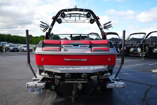 Slide: The Image of 2014 Supra Launch SA 350-550 boat, red exterior, parked on pavement. - 6