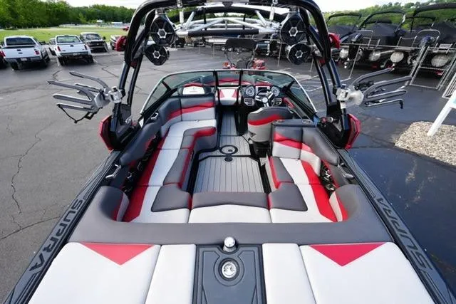 Slide: The Image of 2014 Supra Launch SA 350-550 boat interior with red and gray seating, docked outdoors. - 8