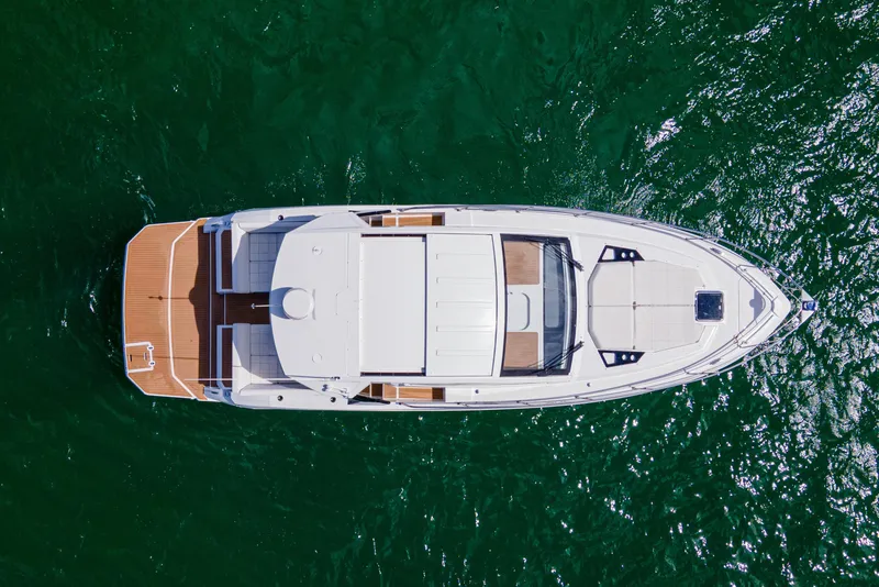 Slide: The Image of Aerial view of 2018 Cruisers Yachts 390 Express Coupe on green water. - 10