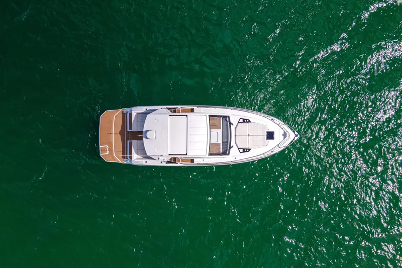 Slide: The Image of Aerial view of 2018 Cruisers Yachts 390 Express Coupe on vibrant green water. - 11