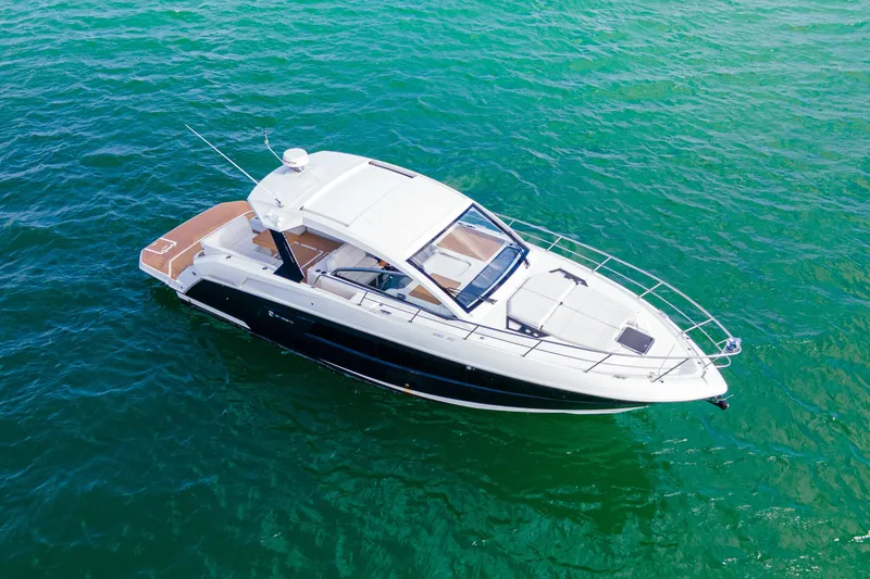 Slide: The Image of 2018 Cruisers Yachts 390 Express Coupe on clear blue water. - 12