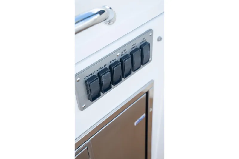 Slide: The Image of Control panel on 2018 Cruisers Yachts 390 Express Coupe, featuring labeled switches. - 15