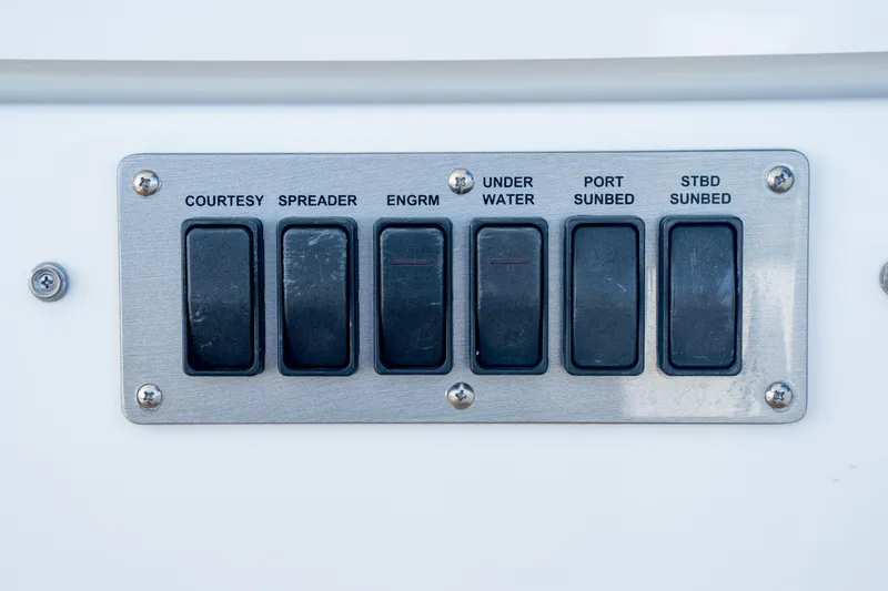 Slide: The Image of Control panel on 2018 Cruisers Yachts 390 Express Coupe with labeled switches. - 16
