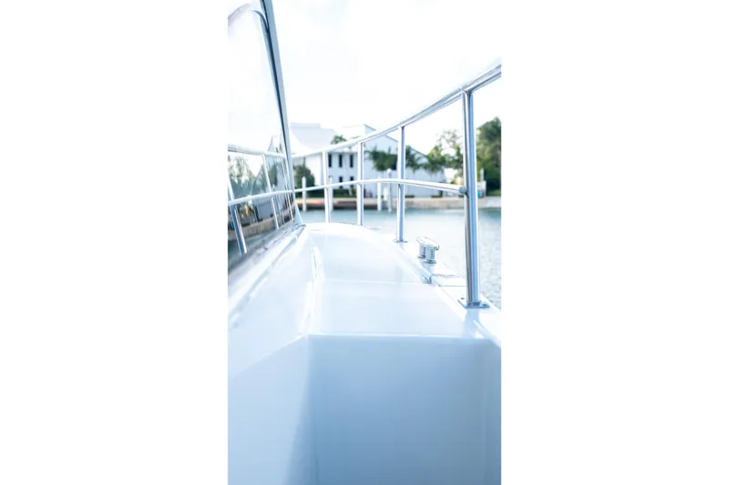Slide: The Image of 2018 Cruisers Yachts 390 Express Coupe deck view with railing and water backdrop. - 17
