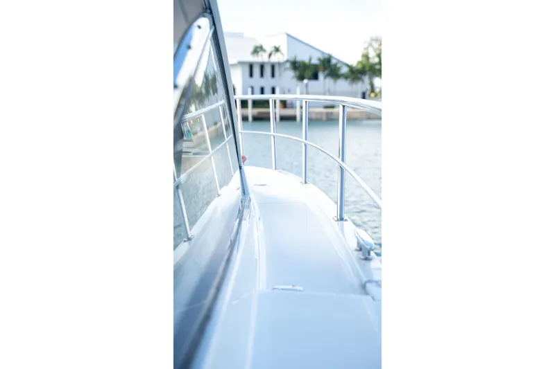 Slide: The Image of Side view of 2018 Cruisers Yachts 390 Express Coupe on water. - 18