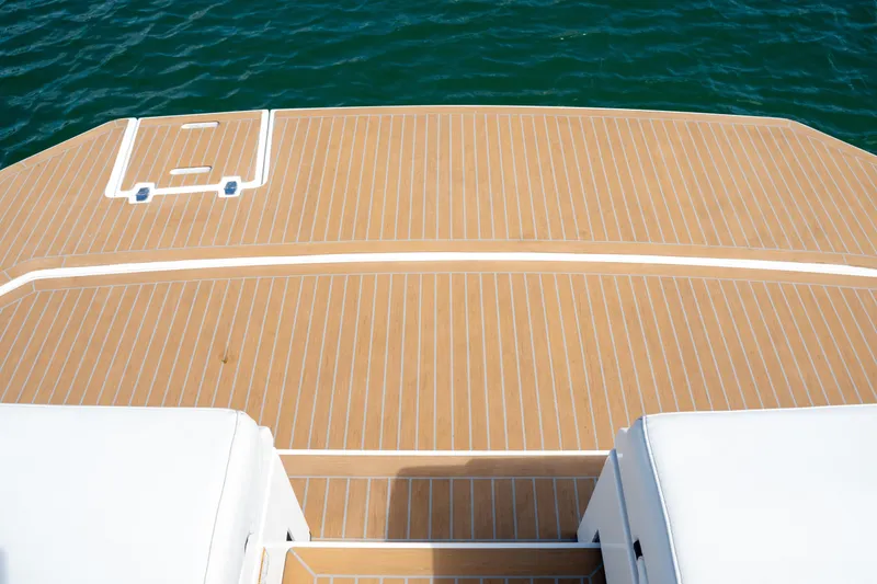 Slide: The Image of 2018 Cruisers Yachts 390 Express Coupe swim platform with teak decking on water. - 22